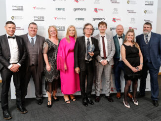 A group of people stood in front of a Wales Business Awards background