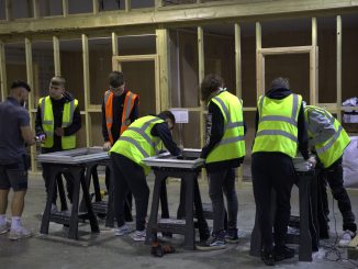 A group of apprentices working at CES wearing high vis jackets.