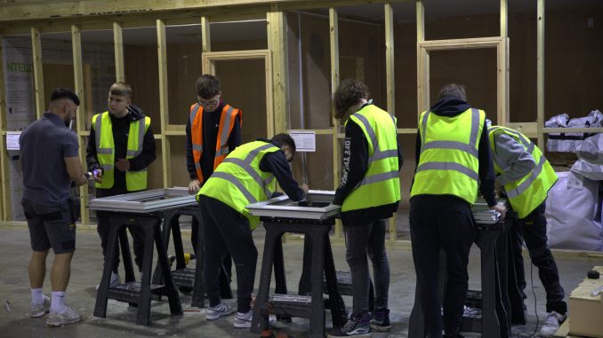 A group of apprentices working at CES wearing high vis jackets.